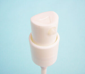 SNXC0205 personal care and cosmetic pump in with with a textured top for easier compression